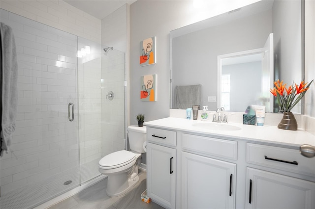 bathroom with an enclosed shower, vanity, toilet, and tile patterned floors