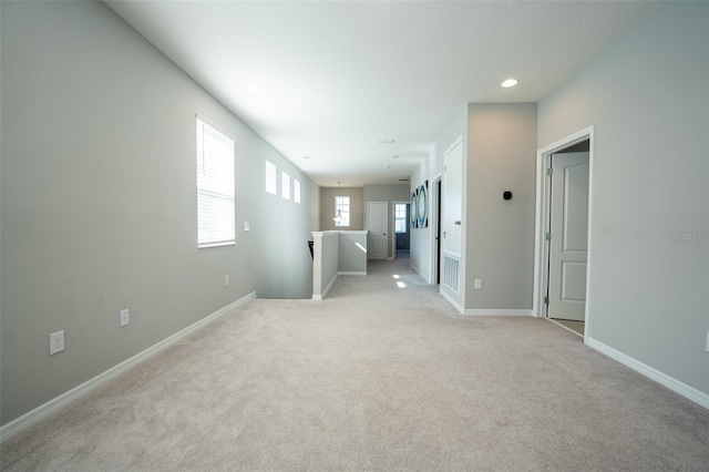 spare room featuring light colored carpet