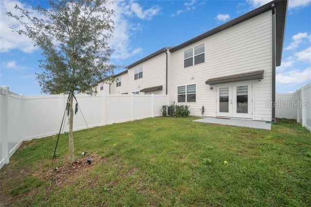 back of property with french doors, a yard, and a patio