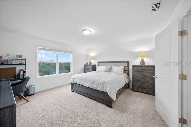 bedroom with light carpet