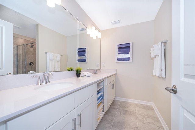 bathroom with tile patterned flooring, vanity, and walk in shower