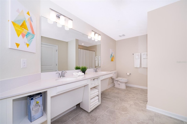 bathroom featuring tile patterned flooring, vanity, and toilet