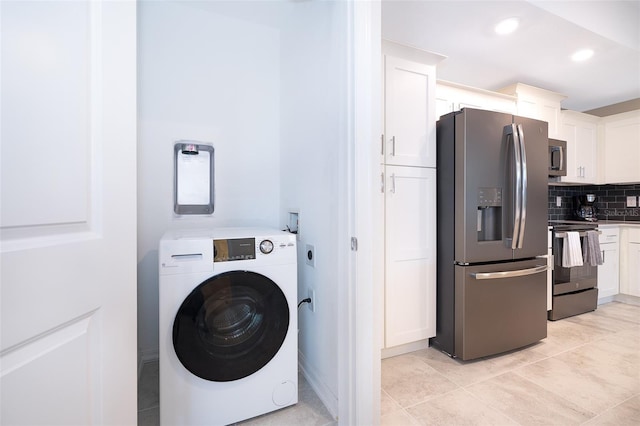 washroom featuring washer / clothes dryer and light tile patterned floors