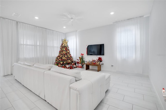 living room featuring plenty of natural light and ceiling fan