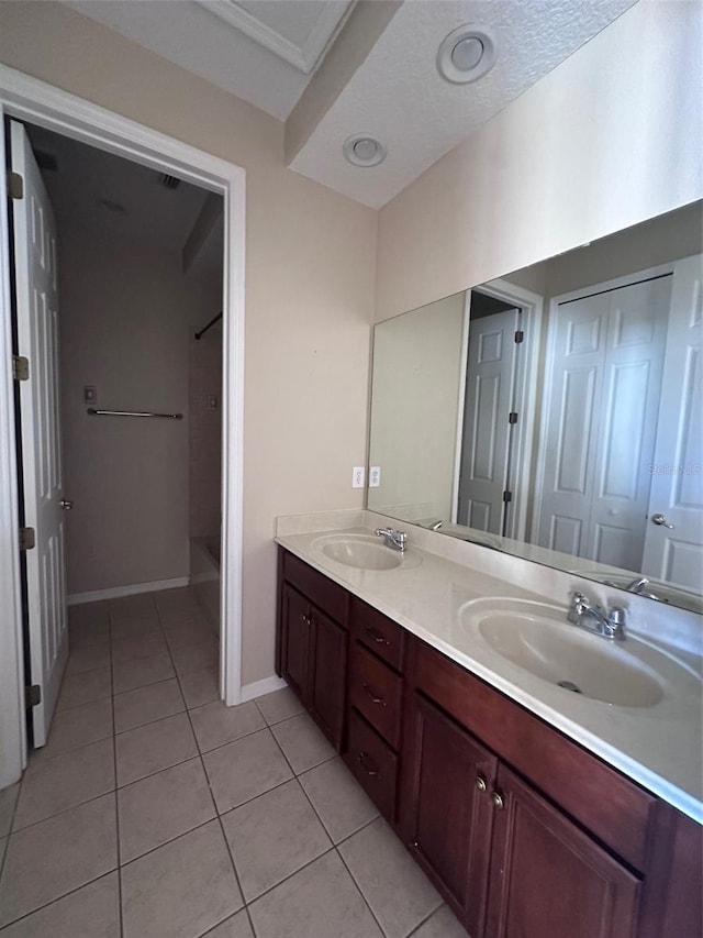 bathroom featuring tile patterned flooring, a textured ceiling, and vanity