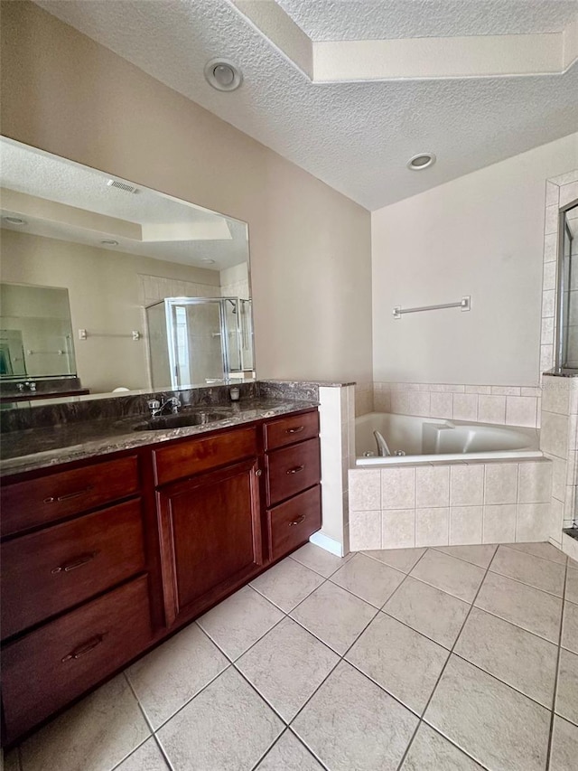 bathroom featuring separate shower and tub, tile patterned flooring, vanity, and a textured ceiling