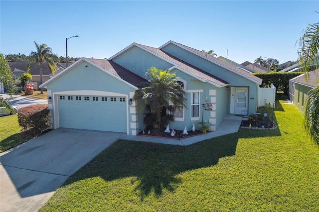 view of front of home with a garage and a front lawn