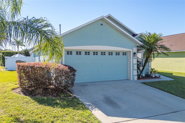 view of front of home with a garage and a front lawn