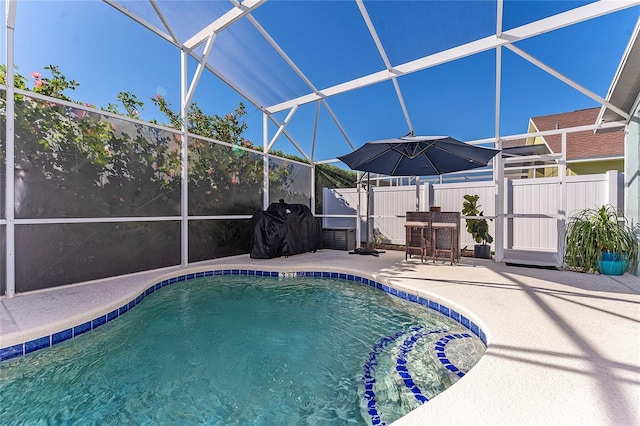 view of swimming pool featuring a lanai and a patio area