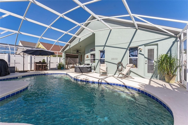 view of swimming pool featuring a lanai, ceiling fan, and a patio