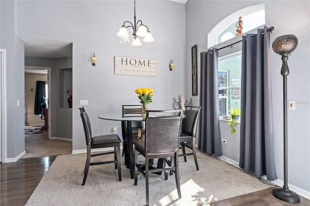 dining area with a notable chandelier and dark wood-type flooring