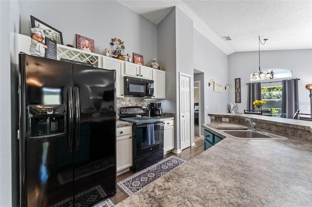 kitchen featuring white cabinets, sink, lofted ceiling, and black appliances