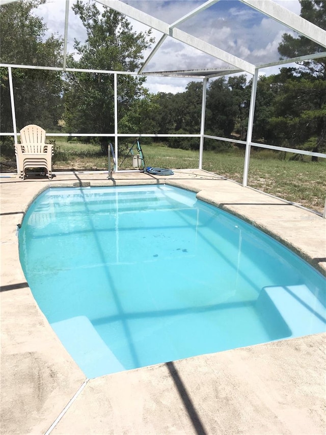 view of pool with a lanai