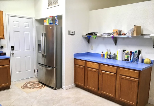 kitchen featuring stainless steel fridge and light tile patterned floors