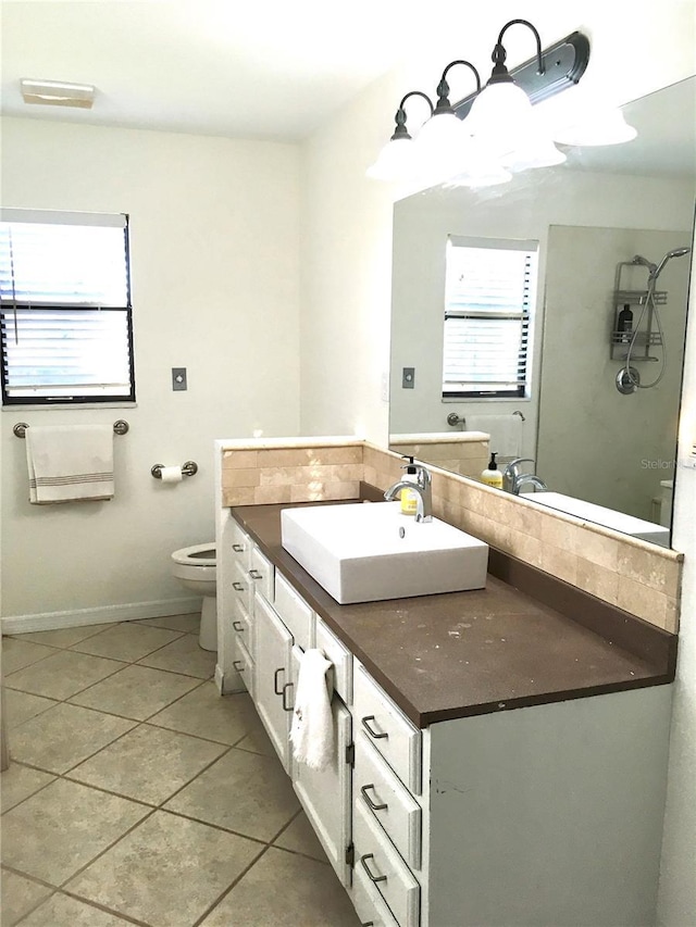 bathroom with tile patterned flooring, vanity, and toilet