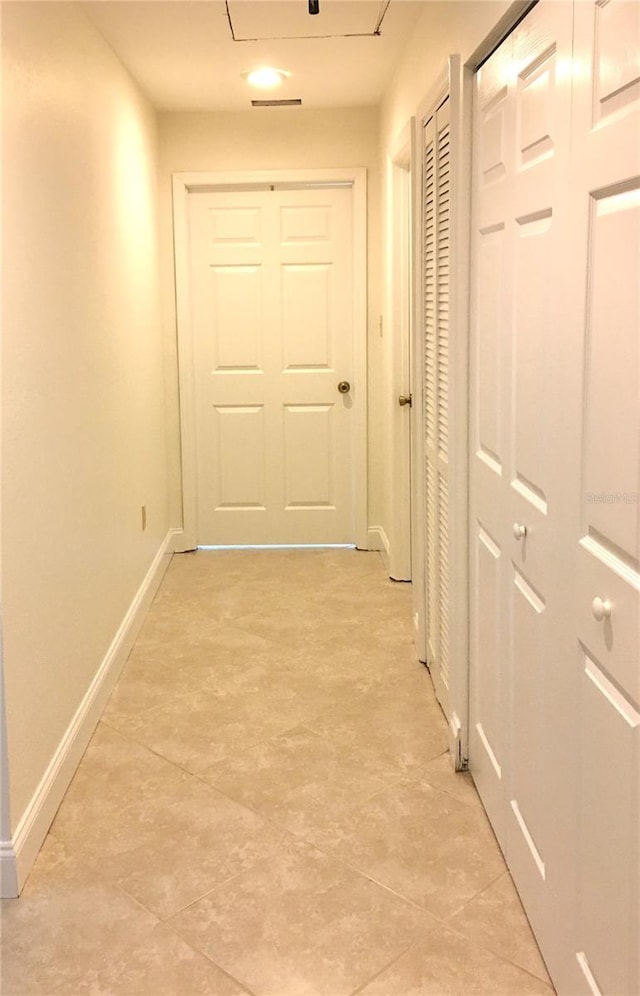 hallway featuring light tile patterned floors