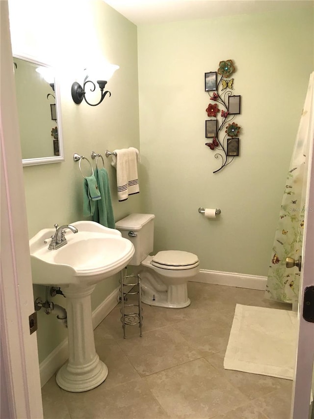 bathroom featuring tile patterned flooring and toilet