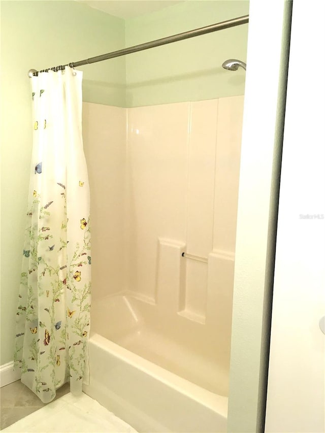 bathroom with shower / bath combination with curtain