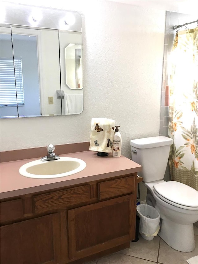 bathroom featuring tile patterned flooring, vanity, toilet, and a shower with curtain