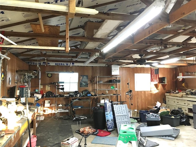 garage with wood walls and ceiling fan