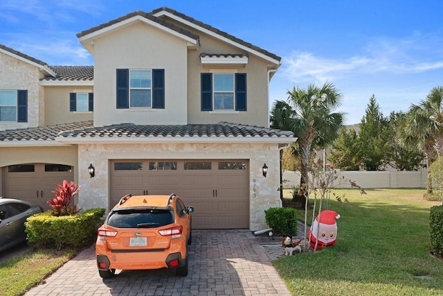 mediterranean / spanish-style house with a garage and a front lawn