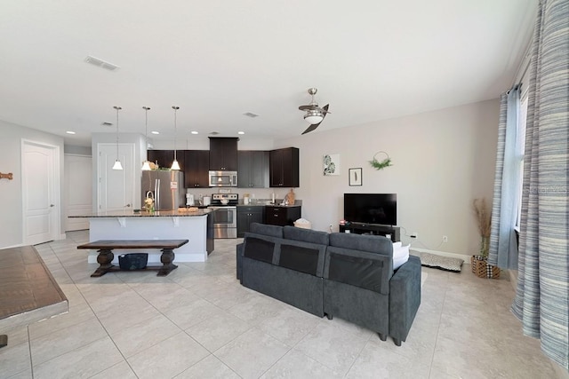 living area featuring recessed lighting, visible vents, baseboards, and light tile patterned floors