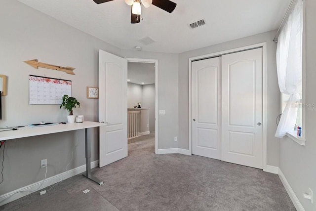 unfurnished bedroom with ceiling fan, a closet, and carpet floors