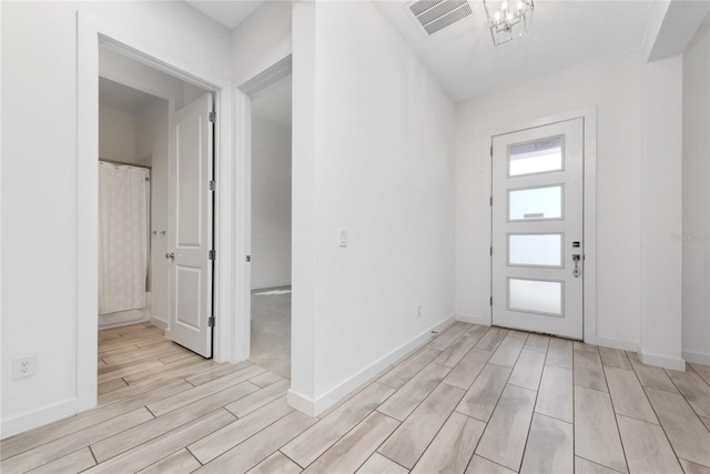 foyer entrance with light hardwood / wood-style floors