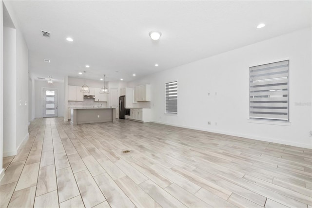 unfurnished living room featuring light wood-type flooring