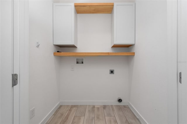 laundry area featuring cabinets, light hardwood / wood-style flooring, washer hookup, and hookup for an electric dryer