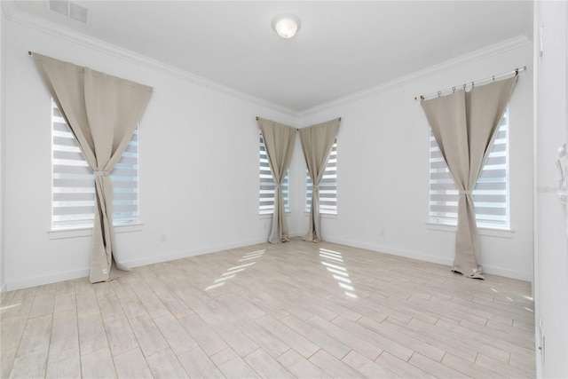 empty room featuring light hardwood / wood-style flooring and ornamental molding