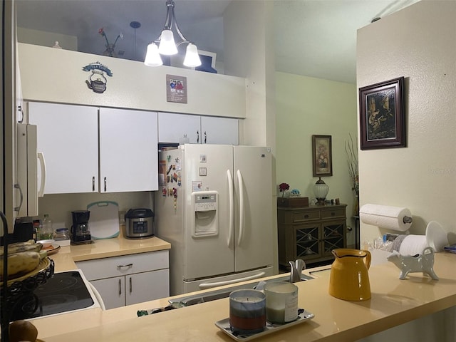 kitchen featuring a chandelier, white cabinetry, hanging light fixtures, and white appliances