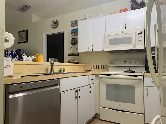 kitchen featuring light wood-type flooring, white appliances, white cabinetry, and sink