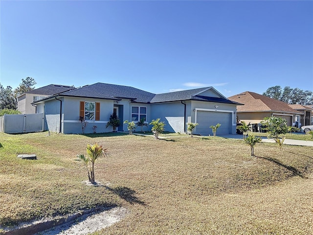 ranch-style home featuring a garage and a front lawn