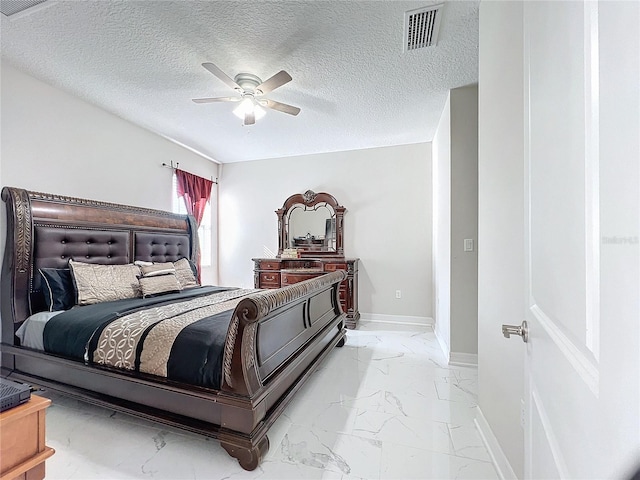 bedroom with a textured ceiling and ceiling fan