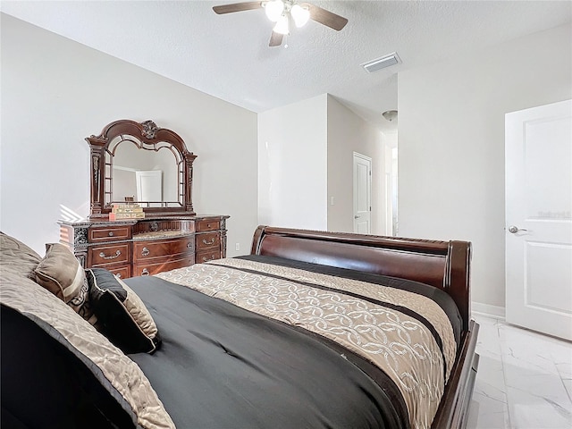 bedroom featuring a textured ceiling and ceiling fan