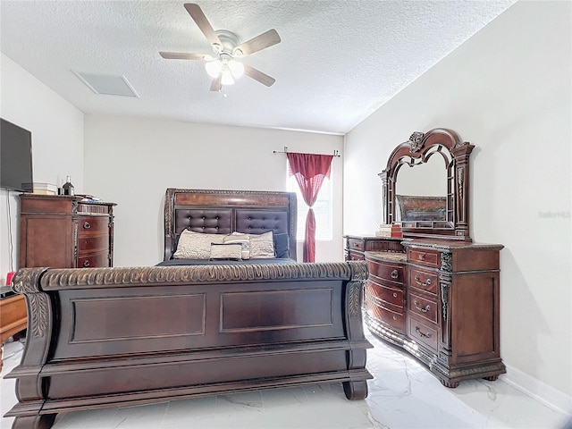 bedroom with a textured ceiling, ceiling fan, and lofted ceiling