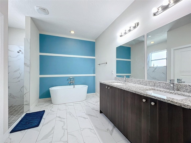 bathroom with vanity, plus walk in shower, and a textured ceiling