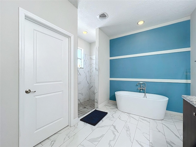 bathroom featuring a textured ceiling, vanity, and shower with separate bathtub