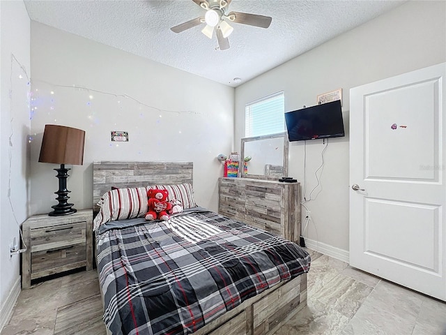 bedroom featuring a textured ceiling and ceiling fan