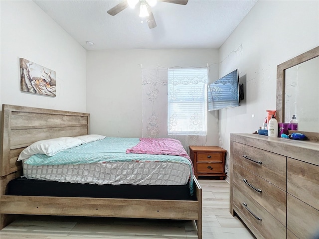 bedroom with ceiling fan and light hardwood / wood-style flooring