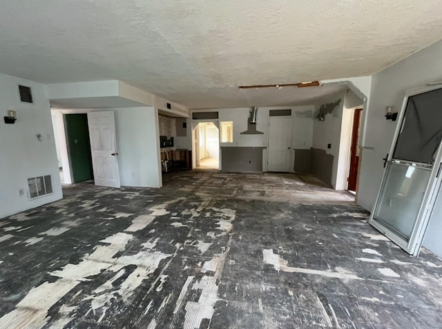 unfurnished living room featuring a textured ceiling