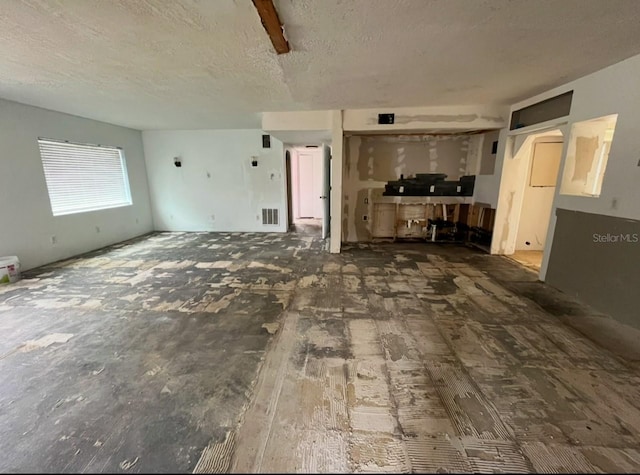 unfurnished living room with a textured ceiling