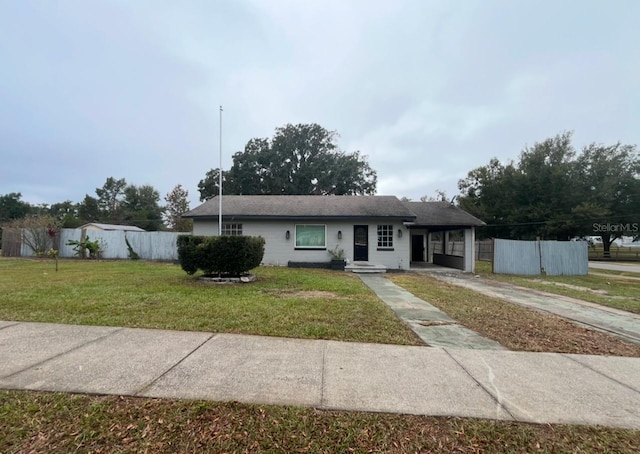 view of front of home with a front lawn and a carport