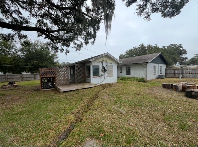 rear view of property with a yard