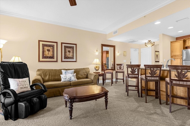 living room featuring crown molding and light carpet