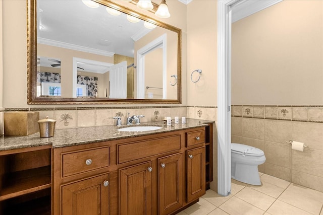 bathroom featuring tile patterned floors, toilet, vanity, tile walls, and ornamental molding