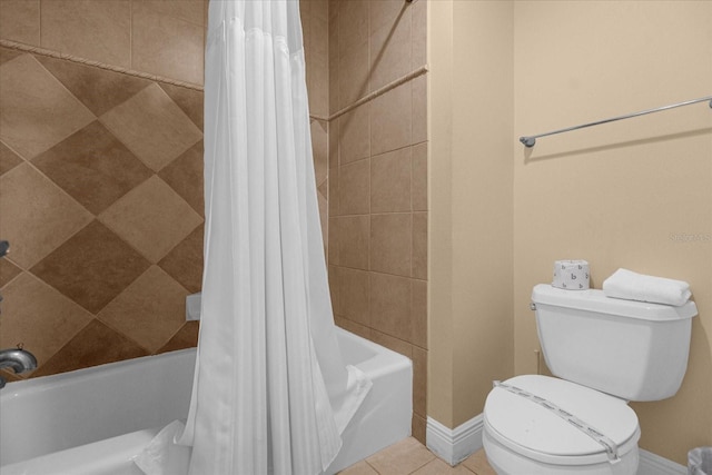 bathroom with tile patterned flooring, toilet, and shower / tub combo