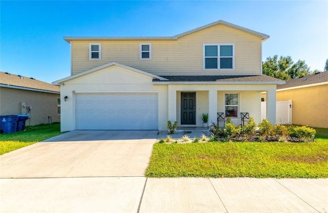 view of front of home with a porch, a front yard, and a garage