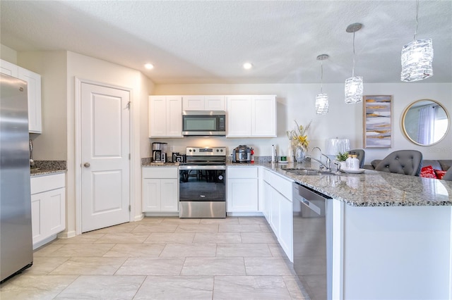 kitchen featuring kitchen peninsula, white cabinetry, sink, and appliances with stainless steel finishes